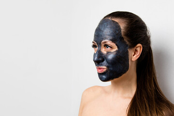 portrait of a beautiful young woman who does facial cosmetic procedures, skin with clay, advertising facial masks