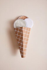 powders with cone in form of ice-cream on beige background, close view, beauty concept 