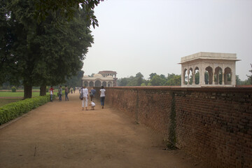 Fototapeta na wymiar Tourists take a walk on a smog day inside red fort located in New Delhi, India