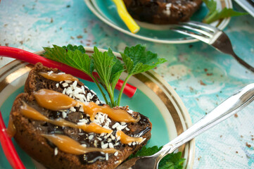 Chocolate cake and jelly candies on a white plate with mint