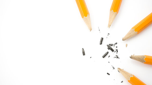 Broken Pencils Are Lying On A White Background Photo