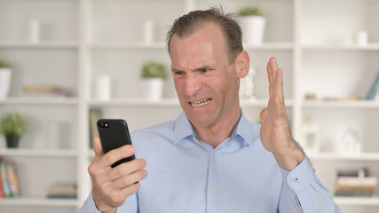 Middle Aged Man Getting Loss on Smartphone