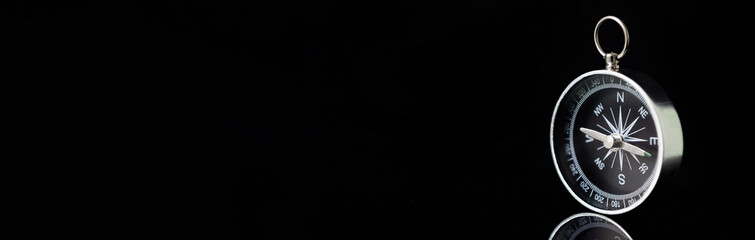 Banner of compass on dark black background with copy space using as direction