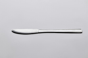 Isolate metallic knife in grey background