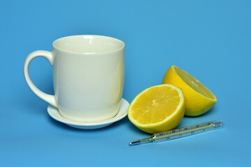 beautiful sliced lemons and a mug with tea on a blue background yellow