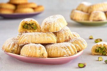 Traditional arabic eid sweets. Maamoul or mamoul cookies with pistachios, dates and walnut . Close...