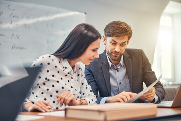 Young employees are working in office together