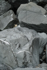 Large boulders forming a sea wall and providing protection from sea water erosion