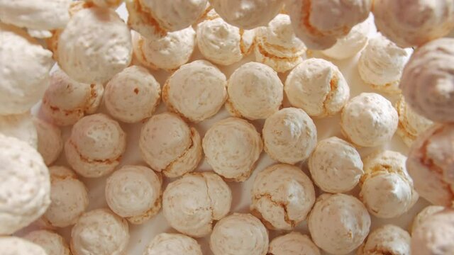 The meringues sweets light pink peach colour fast counterclockwise rotation table top still life