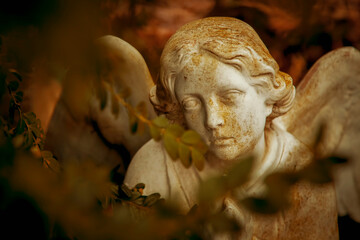 Death. Close up stone statue of an angel as symbol of pain, fear and end of life. Horizontal image.