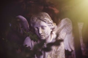 Death. Sad angel. Ancient sculpture. Horizontal image.