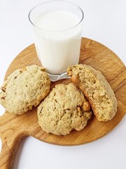 Homemade cookies with a glass of milk on a wooden kitchen Board on a white background.