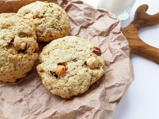 Homemade cookies with a glass of milk on a wooden kitchen Board on a white background.