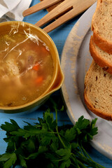 tasty tripe soup in a small bowl next to dry bread