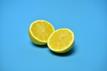 Naklejka na ściany i meble beautiful sliced lemons on a blue background yellow