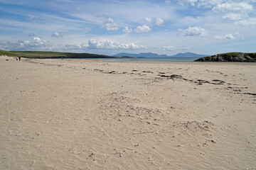 The beach at Abeffraw with the mountains of Snowdonia National Park in the distance