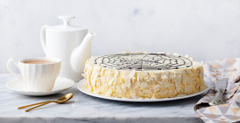 Traditional Hungarian Esterhazy cake, torte with cup of coffee. Marble background. Copy space.