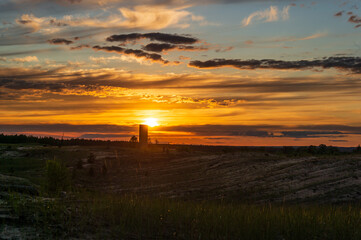 Fototapeta premium water tower on a background of sunset and clouds1