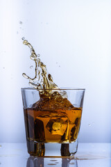 whiskey splashes in a glass on a light background7