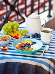 Healthy breakfast with coffee served on table. Outdoor background.