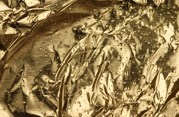 Golden metallic background with water drops (lightly striped texture)