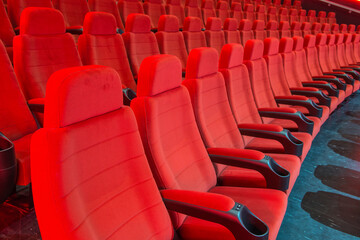Fototapeta premium Rows of red empty red seats in a movie theatre.
