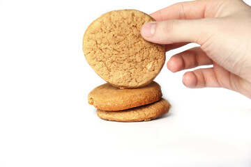 Homemade cookies in hand on a white background. Homemade cookies on a white background. Homemade simple baking. shortbread