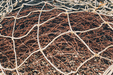 Background of tangled fishing nets, toned.