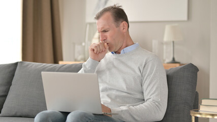 Sick Middle Aged Businessman Coughing on Sofa