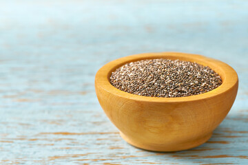 chia seeds in a wooden bowl  on a rustic background, selective focus.
