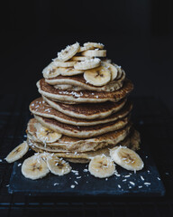 Vegan banana pancakes on dark background