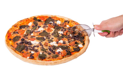 Man's hand cuts the pizza with a pizza cutter, angle view. Delicious pizza with mozzarella, feta,...