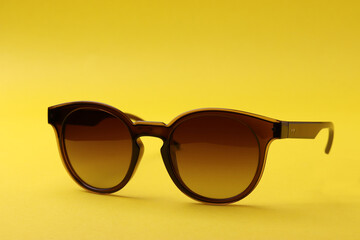 a pair of female or male sunglasses as the means of sun protection or fashionable accessories on...