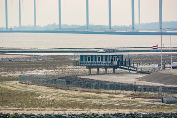 Delfzijl, Netherlands - January 11, 2020. Small restaurant on the shore De Kleine Zeemeermin at low tide by Ems river