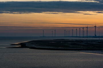 Fototapeta na wymiar Wind electricity on the coast at night in Delfzijl, Netherlands