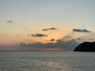 Colorful panoramic view of Sicily coastline with cloudy sunset sky, Mediterranean sea and mountains on background
