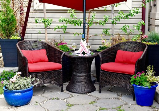 Outdoor Oasis On Summer Patio In Home Landscaped Garden To Relax With Afternoon Wine On Comfortable And Cosy Wicker Chairs