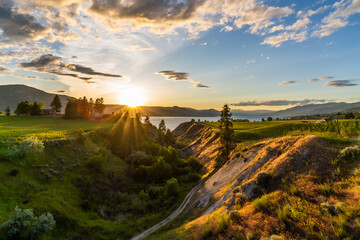 Naklejka na ściany i meble A beautiful sunset Over The Vineyards of the Okanagan wine valleys and Okanagan Lake
