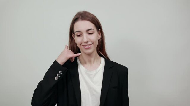 Imitates telephone conversation, keeps hand near ear as if holding mobile phone. Talking on smartphone simulates. Call with her finger. Asks to recall. Pretending that speaking with somebody
