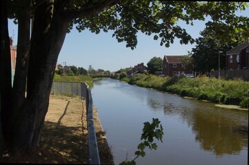 Fototapeta premium canal in the village on a sunny day