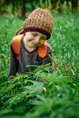 6 years old boy in hemp bushes