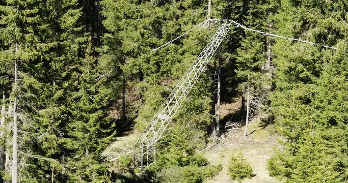 Aerial of snapped power line pole. Electricity Line leaning on trees after storm damage