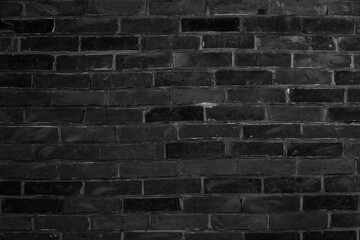 Black brick wall background inside of the room.