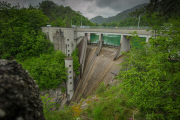 Fototapeta premium Small but steep dam for hydroelectric plant in Moste, Slovenia. View of the hidroelectric dam from above, looking down.