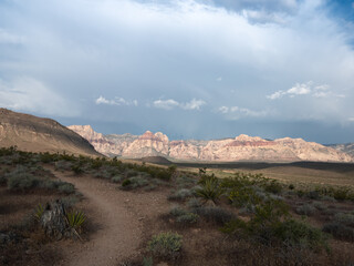 Hiking trail with a spring storm moving across Red Rock Canyon.