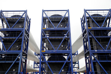 Newly constructed wings of wind-turbines ready to be transported to an offshore windpark, Holland