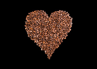 Coffee beans arranged in a shape of heart on black background