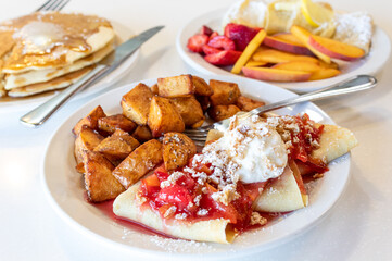 Crepes and Potatoes with Colorful Fruit and Fresh Whipped Cream