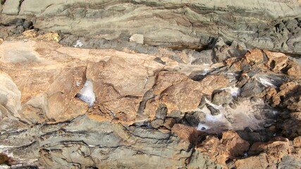 contemplate the sunset and the sea from the cliffs next to the Golden sand