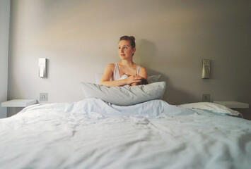 Maternity- mother and baby on the bed with grey background wall